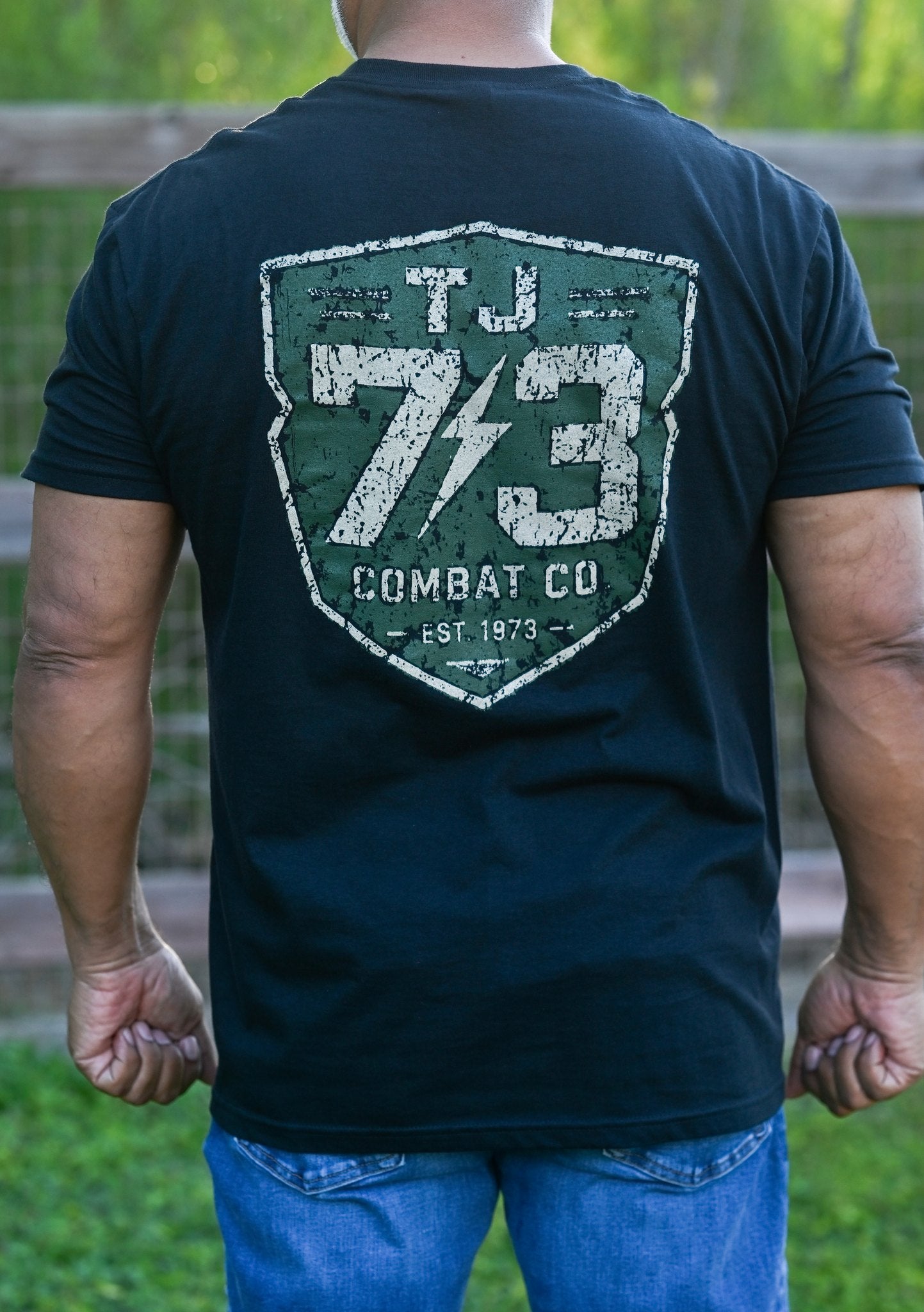 TJ73 Combat Co. black tee — back 73 shield logo