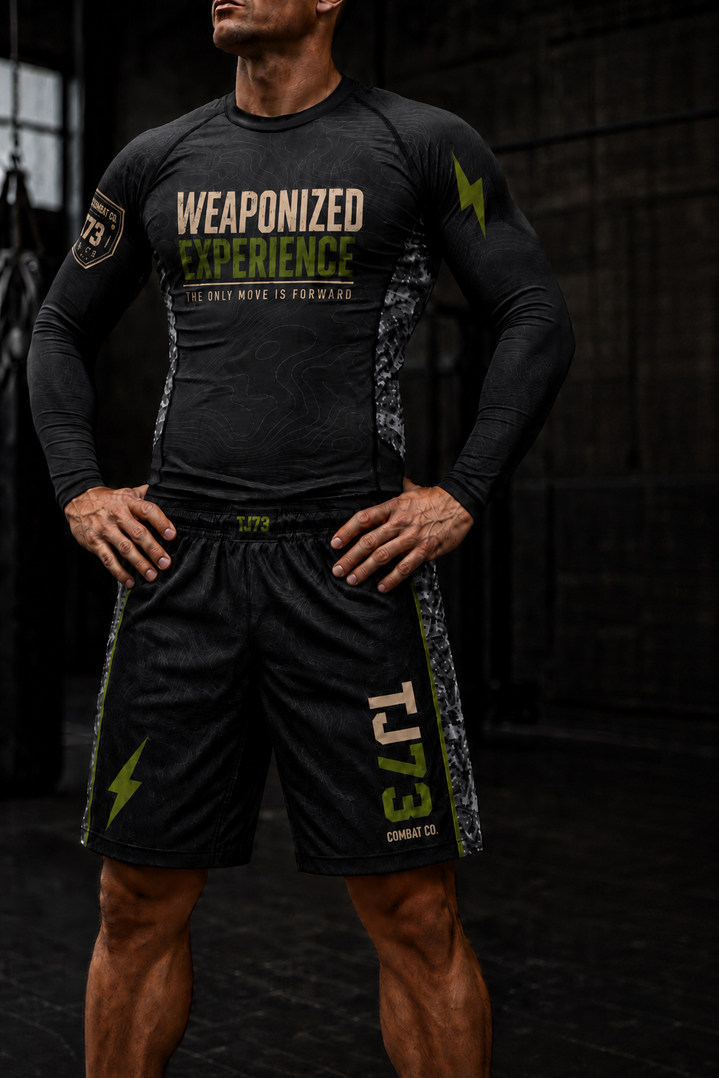 Athlete wearing TJ73 Combat Co. long sleeve rashguard and fight shorts, front view